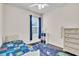 Bedroom featuring wood floors, ceiling fan, a colorful rug, and neutral paint at 11754 Barletta Dr, Orlando, FL 32827