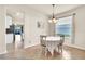 Bright dining area with tiled floors, a round table, and a large window that allows natural light to illuminate the space at 11754 Barletta Dr, Orlando, FL 32827