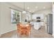 Bright eat-in kitchen with white cabinetry and modern appliances, flooded with natural light at 11754 Barletta Dr, Orlando, FL 32827