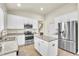 Modern kitchen featuring white cabinets, stainless steel appliances, granite countertops, and a kitchen island at 11754 Barletta Dr, Orlando, FL 32827