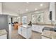 Bright kitchen featuring white cabinets, granite countertops, and a kitchen island overlooking the dining area at 11754 Barletta Dr, Orlando, FL 32827