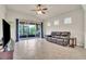 Spacious living room with sliding glass doors to the lanai and vaulted ceilings at 11754 Barletta Dr, Orlando, FL 32827