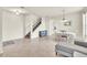 Open-concept living room with tiled floors, staircase, and natural light creating a welcoming atmosphere at 11754 Barletta Dr, Orlando, FL 32827