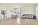 Bright living room with tiled floors, a gray sofa, and a dining area with a round table and seating at 11754 Barletta Dr, Orlando, FL 32827