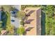 Overhead view displaying the building's layout, tile roof, parking area, and surrounding trees, providing a sense of location at 1290 Grady Ln # 20232, Davenport, FL 33896