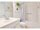 Clean, all-white bathroom with shower-tub combo and vanity at 1290 Grady Ln # 20232, Davenport, FL 33896