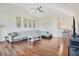 Open concept living room featuring a ceiling fan and hardwood floors that flow into the kitchen at 1290 Grady Ln # 20232, Davenport, FL 33896