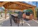 Outdoor kitchen area with grill, overhead fan, seating at the granite bar, and paver patio at 1290 Grady Ln # 20232, Davenport, FL 33896