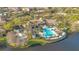 Aerial view of the community pool, amenity center, and bocce ball court with several palm trees at 1290 Grady Ln # 20232, Davenport, FL 33896