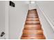 Staircase featuring hardwood steps and white risers with white railing at 1290 Grady Ln # 20232, Davenport, FL 33896