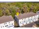 Aerial view of the townhome complex near a lush wooded area, marked with a yellow pin at 1304 Spotted Sandpiper Loop, Winter Springs, FL 32708