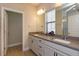 Bright bathroom with double sinks, white cabinets, and a glass-enclosed shower at 1304 Spotted Sandpiper Loop, Winter Springs, FL 32708