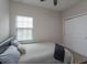 Simple secondary bedroom with double closet, neutral decor and window for natural light at 1304 Spotted Sandpiper Loop, Winter Springs, FL 32708