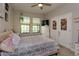 Comfortable bedroom featuring a soft bed, a dresser, and natural light from the windows at 1304 Spotted Sandpiper Loop, Winter Springs, FL 32708