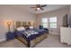 Comfortable main bedroom featuring a large bed, side tables, and a reading chair at 1304 Spotted Sandpiper Loop, Winter Springs, FL 32708