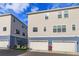 Exterior shot of the townhomes showing two-tone paint and one car garage at 1304 Spotted Sandpiper Loop, Winter Springs, FL 32708