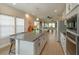 Spacious kitchen island with bar seating and an open view of the living area at 1304 Spotted Sandpiper Loop, Winter Springs, FL 32708