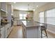 Bright kitchen with pendant lighting over the island and stainless steel appliances at 1304 Spotted Sandpiper Loop, Winter Springs, FL 32708