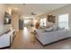 Open-concept living room flowing into kitchen with stainless steel appliances at 1304 Spotted Sandpiper Loop, Winter Springs, FL 32708