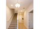 Bright hallway featuring a carpeted staircase, wood floors, and a closet for storage at 1304 Spotted Sandpiper Loop, Winter Springs, FL 32708