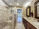 Elegant bathroom features a granite countertop vanity and a tiled glass shower with a built-in bench at 1312 Golfside Dr, Winter Park, FL 32792