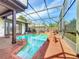 Private pool area with rock features and a screened enclosure, ideal for outdoor enjoyment at 1312 Golfside Dr, Winter Park, FL 32792