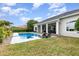 A large pool and a covered outdoor living area make this backyard perfect for entertaining at 1403 Lake Whitney Dr, Windermere, FL 34786