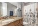 Bathroom featuring a vanity with a granite countertop, and patterned shower curtain at 1403 Lake Whitney Dr, Windermere, FL 34786