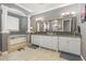 Bathroom featuring a large soaking tub, step-up platform, dual vanities, and decorative mirrors at 1403 Lake Whitney Dr, Windermere, FL 34786