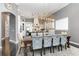 View of the dining room with seating for eight, adjacent to a modern kitchen with an island at 1403 Lake Whitney Dr, Windermere, FL 34786