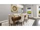 Elegant dining room featuring a wood table, fabric chairs, and a decorative chandelier at 1403 Lake Whitney Dr, Windermere, FL 34786