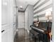 Hallway with a piano, dark wood floors, and a painted accent wall at 1403 Lake Whitney Dr, Windermere, FL 34786