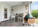 Inviting outdoor kitchen featuring stainless steel appliances, white tiled backsplash, and a separate green ceramic smoker at 1403 Lake Whitney Dr, Windermere, FL 34786