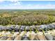 Aerial view of well-planned neighborhood close to a lush green forest and blue skies at 14090 Alafaya Oak Bnd, Orlando, FL 32828