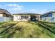 Expansive backyard features lush green grass, partial shade, and a white vinyl fence at 14090 Alafaya Oak Bnd, Orlando, FL 32828