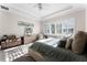 Bedroom with queen bed, tray ceiling, lots of sunshine from the large window, and cozy decor at 14090 Alafaya Oak Bnd, Orlando, FL 32828