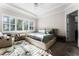 Bedroom featuring a queen bed with light green bedding, large sunny window with white shutters, and tray ceiling at 14090 Alafaya Oak Bnd, Orlando, FL 32828