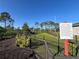 Fenced dog park with lush grass and visible regulations, perfect for pets to exercise and socialize safely at 14090 Alafaya Oak Bnd, Orlando, FL 32828