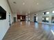 Expansive empty room with tile flooring and multiple windows, perfect for events or flexible space at 14090 Alafaya Oak Bnd, Orlando, FL 32828