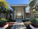 Inviting entrance with stone columns, beautiful landscaping and a gray patterned walkway leading to the building at 14090 Alafaya Oak Bnd, Orlando, FL 32828