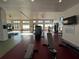 Spacious gym with modern fitness equipment, ample natural light, and fitness room rules on the wall at 14090 Alafaya Oak Bnd, Orlando, FL 32828