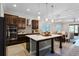 Modern kitchen featuring a center island, sleek countertops, stainless steel appliances, and contemporary lighting at 14090 Alafaya Oak Bnd, Orlando, FL 32828