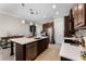 Well-lit kitchen with a central island, modern stainless steel appliances, and seamless flow to the dining area at 14090 Alafaya Oak Bnd, Orlando, FL 32828