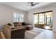 Cozy living room with comfortable sectional sofa, natural light, and seamless access to the outdoor patio at 14090 Alafaya Oak Bnd, Orlando, FL 32828