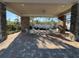 Relaxing covered patio featuring brick flooring, stone columns, comfortable seating and serene outdoor views at 14090 Alafaya Oak Bnd, Orlando, FL 32828