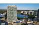 Stunning exterior view of a high-rise building with a beautiful blue lake in the background at 150 E Robinson St # 405, Orlando, FL 32801