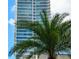 Modern high-rise building with a palm tree in the foreground, reflecting tropical city living at 150 E Robinson St # 405, Orlando, FL 32801