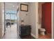 Hallway leading to a living area and bathroom with hardwood floors, and modern lighting at 150 E Robinson St # 405, Orlando, FL 32801