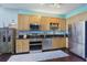 Well-equipped kitchen featuring stainless steel appliances, light wood cabinets, and dark countertops at 150 E Robinson St # 405, Orlando, FL 32801