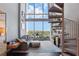 Bright living room with high ceilings, a spiral staircase, and expansive windows overlooking the city at 150 E Robinson St # 405, Orlando, FL 32801